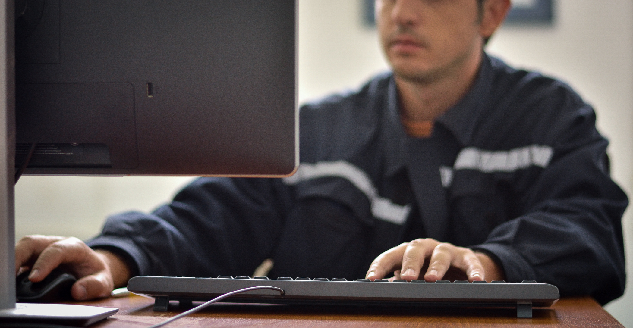 Team member working online using a desktop computer at desk