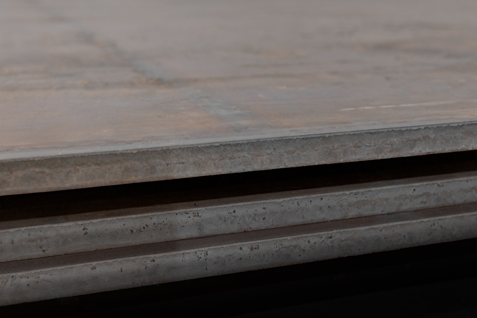 1 inch A514 B steel plates stacked up inside O'Neal Steel warehouse